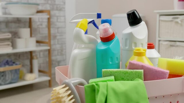 Basket with cleaning supplies in bathroom, closeup