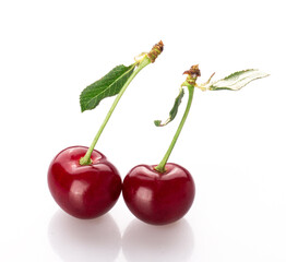 fresh cherry berries with a green leaf isolated on a white background