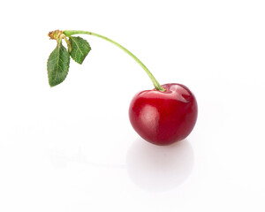 fresh cherry berries with a green leaf isolated on a white background