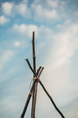 Branches teepee against the sky close up