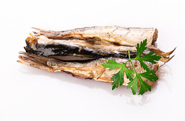 sprats with a sprig of fresh parsley isolated on a white background