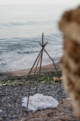 Branches teepee on the beach