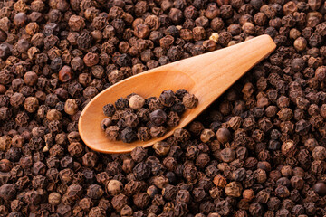 black pepper peas in a wooden spoon and scattered 
