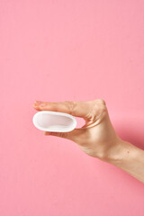 Menstrual cup eco friendly reusable and silicone in woman's hand isolated on a white background