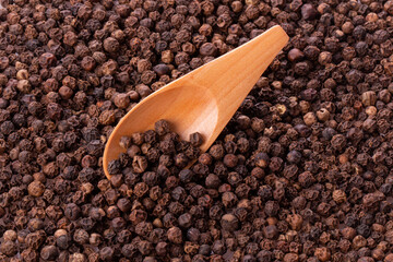 black pepper peas in a wooden spoon and scattered 