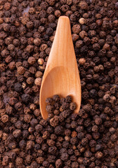 black pepper peas in a wooden spoon and scattered 