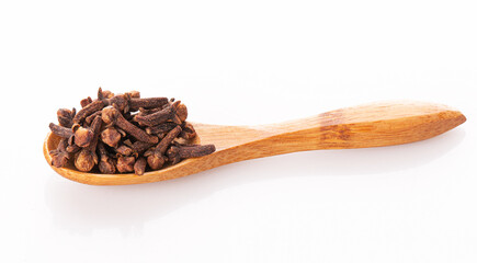 clove seasoning in a wooden spoon isolated on a white background