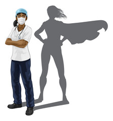 A nurse or doctor super hero woman in surgical or hospital scrubs with stethoscope and mask PPE. With arms folded and serious but caring look. Revealed as a superhero by the shape of her shadow.