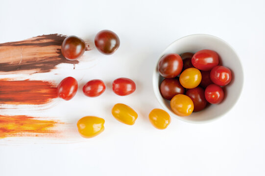 Scattered Tomatoes on a white background with paint 