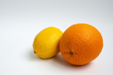 Orange and lemon close up on a white background
