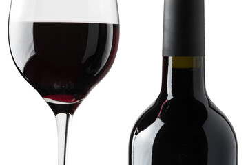 Detail of a glass of red wine next to a bottle on a black background