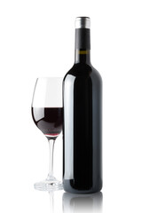 Glass of red wine next to a bottle isolated on white background