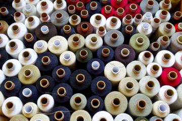 Threads wound on spools laid side by side