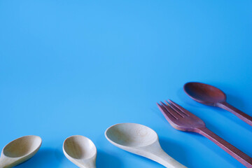 wooden spoon and fork on blue background