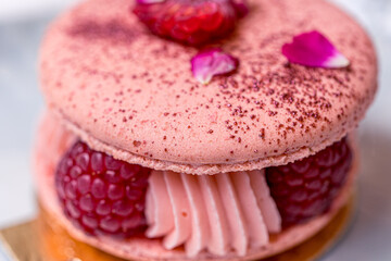 Soft focus background. Pink Raspberry Macaron cookies on blue plate. Tea time. Blue table background. Top view. 
