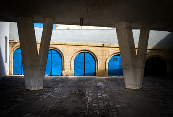 Blue garages under the bridge at the port of Malta's capital. Valleta