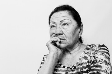 Portrait of elderly senior woman, back and white photo. Thinking about passed years. Loneliness, solitude. Black and white photo.