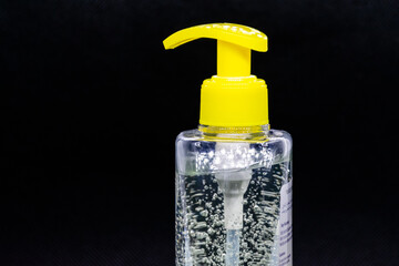 a close up view of hand sanitizer in a black background