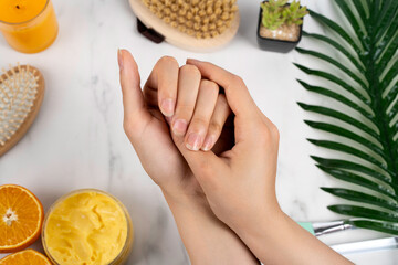 natural manicure girl's hands on the background of marble and bathroom