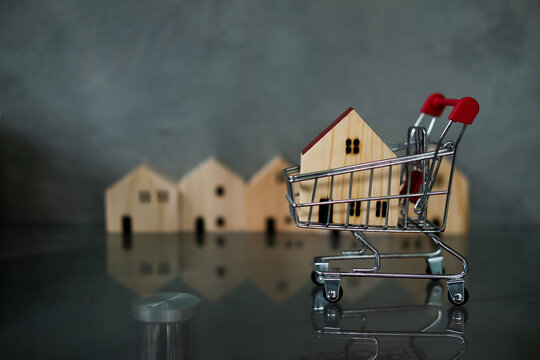 Wood house in small shopping cart. Concept of shop new house promotion