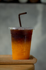 Cold brew coffee mixed with fresh orange juice in plastic glass