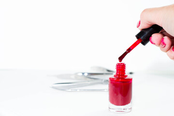 bottle of red nail Polish on a white background isolated