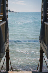sea ​​view between two wooden arbors
