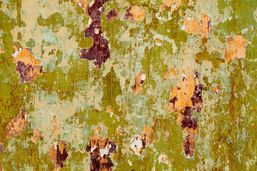 Old background with multi-colored paint was peeling on the surface.