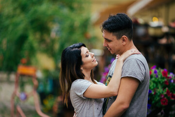 A couple in love slowly walks the streets of the city on a cool autumn morning.