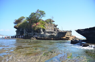 Tanah Lot is a rock formation off the Indonesian island of Bali. It is home to the ancient Hindu pilgrimage temple Pura Tanah Lot, a popular tourist and cultural icon for photography. 