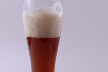 wheat brewed malt beer with foam in a glass