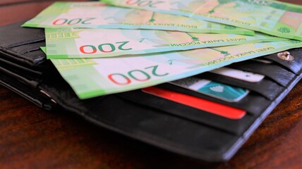Russian money with a black wallet closeup