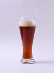 wheat brewed malt beer with foam in a glass