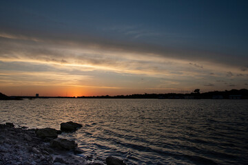 Sunrise on lake as sun appears on horizon