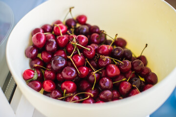 Organic red cherry fruits in the big plate