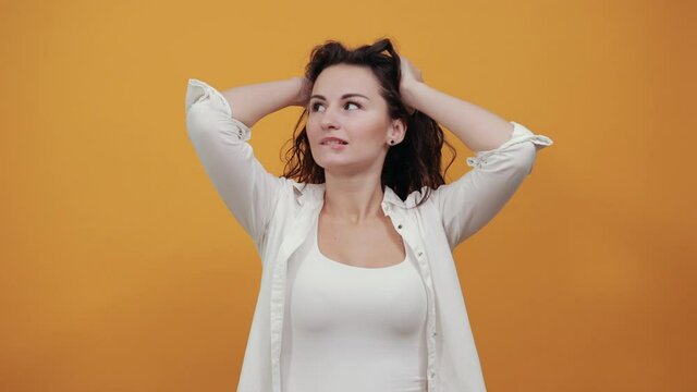 Holding head with both of hands can not believe shocked and despair being in panic, having forgetful look. Frustrated nervous freaking out, worrying because messed up. Young attractive woman