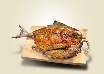Grilled fish. Whole fish is grilled using spices, served with a sprinkling of tomato paste sauce.