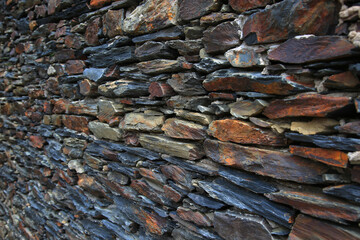Front view of an old natural stone wall. Background image.