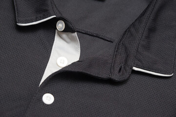 Blank black polo shirt with three white buttons. Polo shirt isolated on white background. Men's clothing.