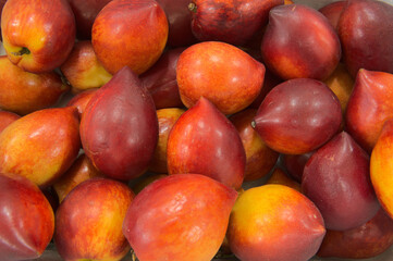 Ripe nectarines sold on market, organic healthy peach, fruit harvest, top view,