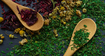 Spices background on wooden spoons. Parsley, chamomile, hibiscus © borja