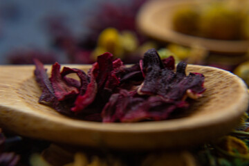 Spices background on wooden spoons.  hibiscus