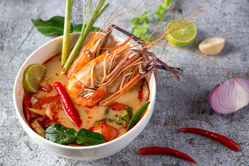 Thai food, Tom Yum Kung in a white cup on a stone pattern