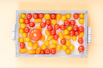 Top view of cherry tomatoes in small wooden crate