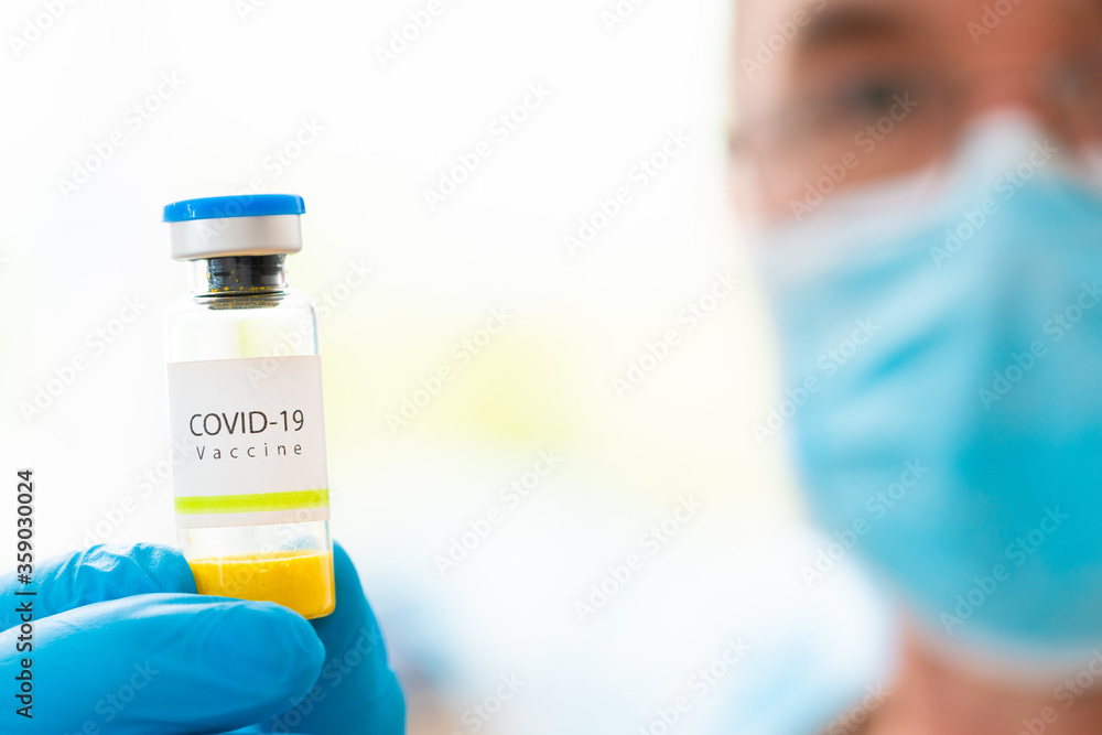 Sticker .Concept  of doctor researcher with Vaccine for Covid-19 on a research laboratory. Doctor that holds in hands Vaccine vial for coronavirus prevention.