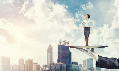 Confident elegant businesswoman presented on metal tray against cityscape background