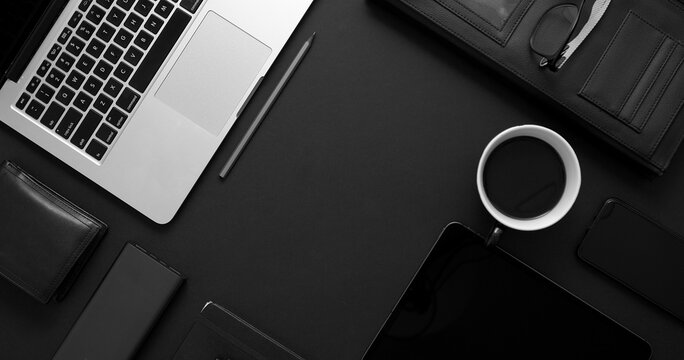 Business Desktop Concept. Mix Of Office Supplies And Gadgets On A Black Table Background