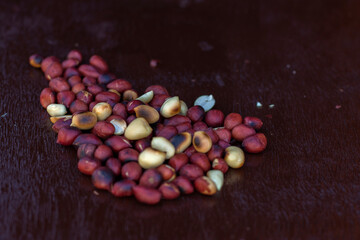 red and white peanuts on wooden surface