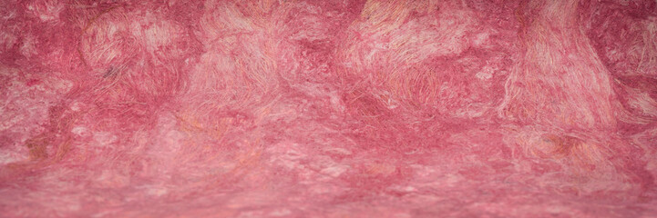 background and texture of burgundy, handcrafted, Mexican amate bark paper made of amate, nettle and mulberry trees, panoramic web banner with a selective focus