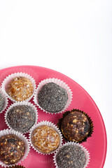 Dried fruit sweets. Balls of prunes, dates and coconut. With a sprinkle of black sesame powder.